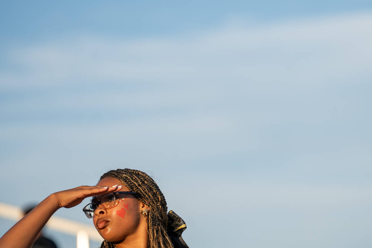 Losee Cheerleader Ivee Dowdell shield her eyes from the sun between cheers during a football ga ...