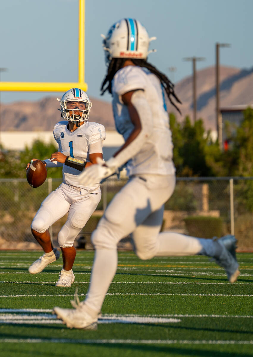 Sloan Canyon's Cade Hoshino looks for an open pass during a football game between Losee an ...