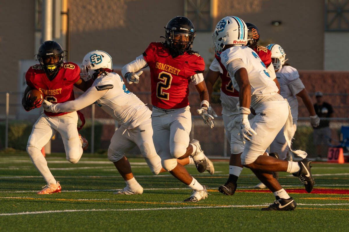 Losee's Carl "CJ" Sparks tries to navigate through defenders during a football g ...