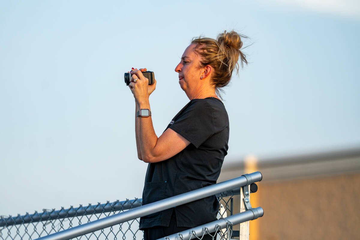 The crowd videotapes a football game between Losee and Sloan Canyon at Somerset Academy Losee C ...