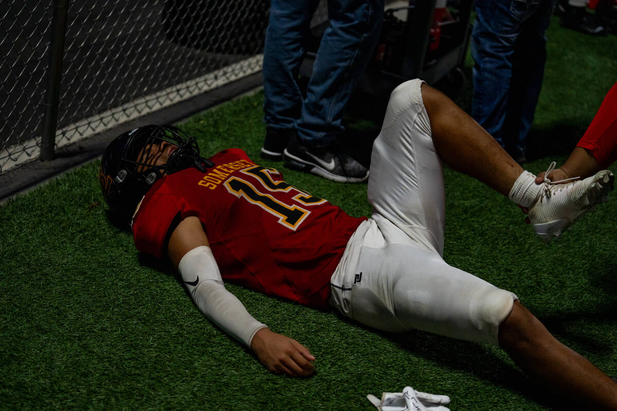 Losee’s Kieran Daniel hamstring is stretched out before the second half of a football ga ...