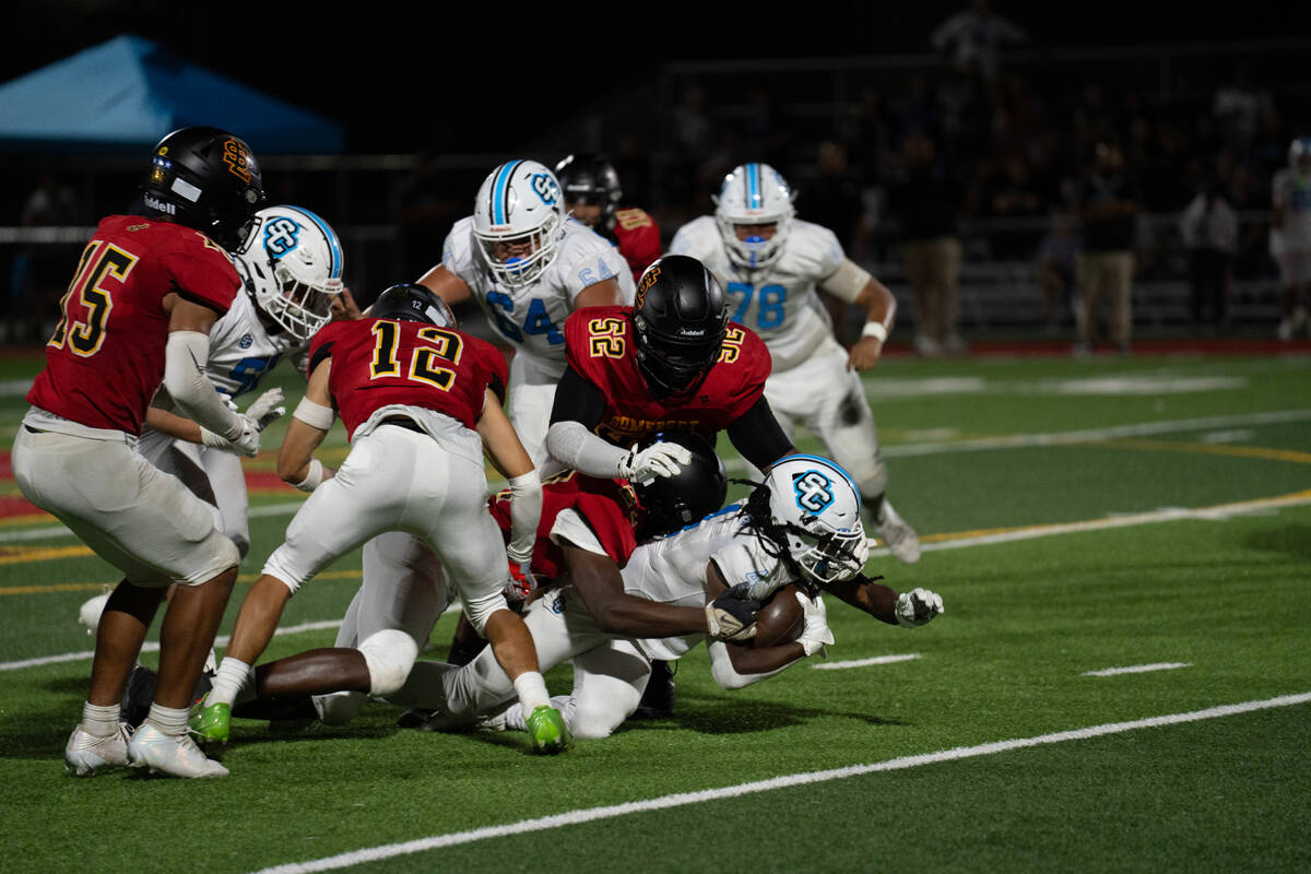 Sloan Canyon's Jermaine Wilson Jr. is tackled during a football game against Losee at Some ...