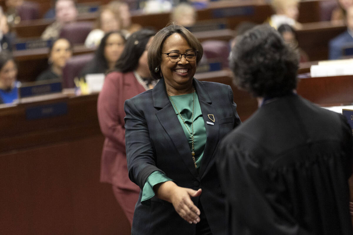 Assemblywoman Daniele Monroe-Moreno, D-North Las Vegas, reaches to shake the hand of Chief Just ...