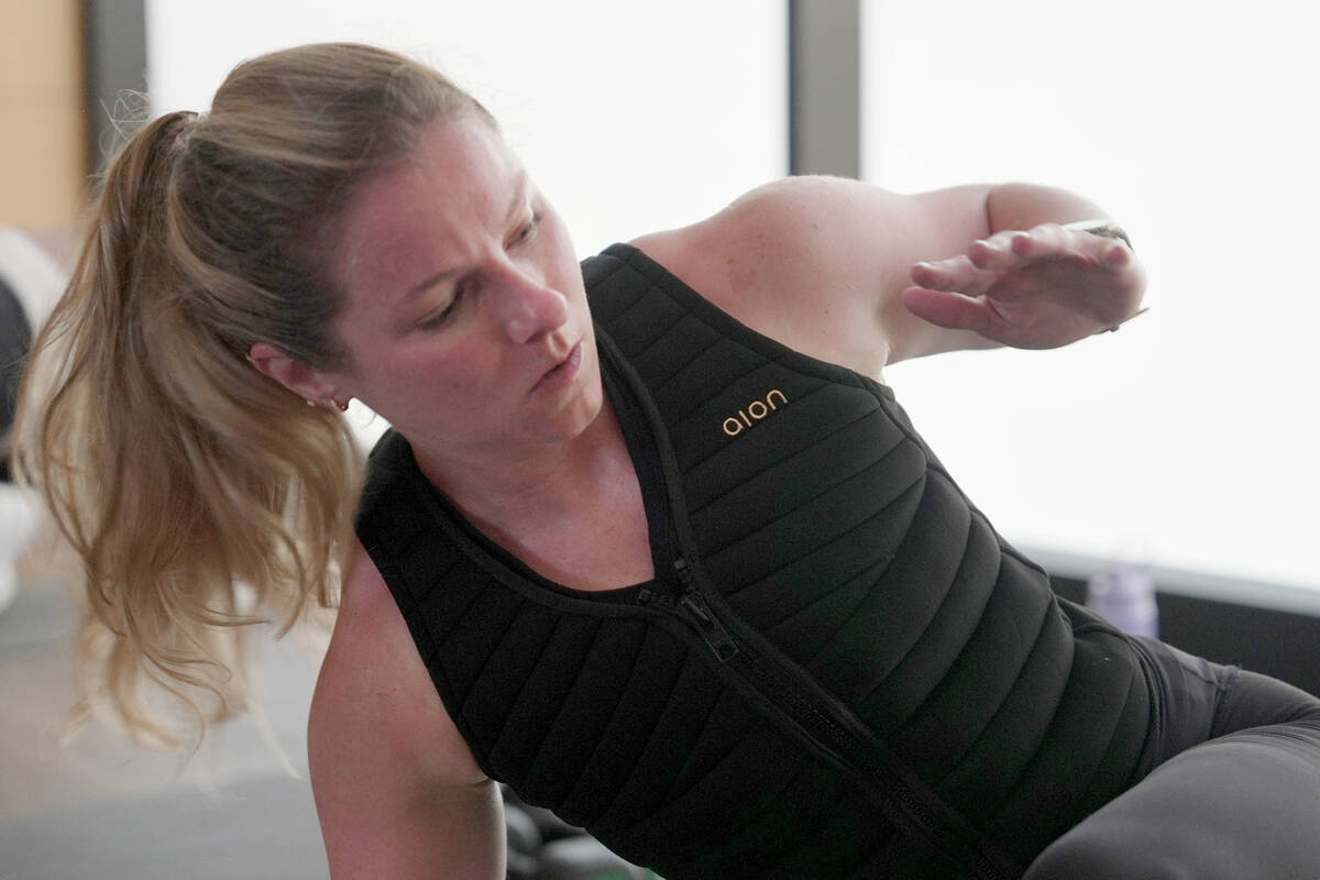 Nora Capocci wears a weighted vest during an MB360 workout class at the Life Time health club i ...