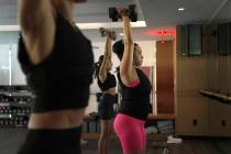 Jannelliz Barragan, center, wears a weighted vest during an MB360 workout class at the Life Tim ...
