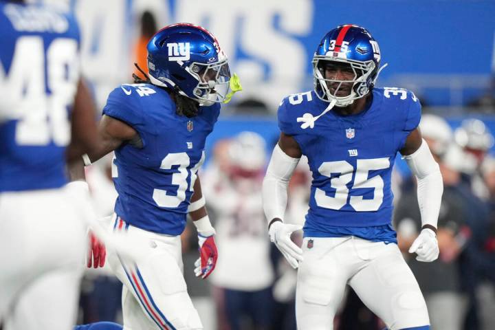New York Giants cornerback Art Green (35) and New York Giants safety K'Von Wallace (34) ce ...