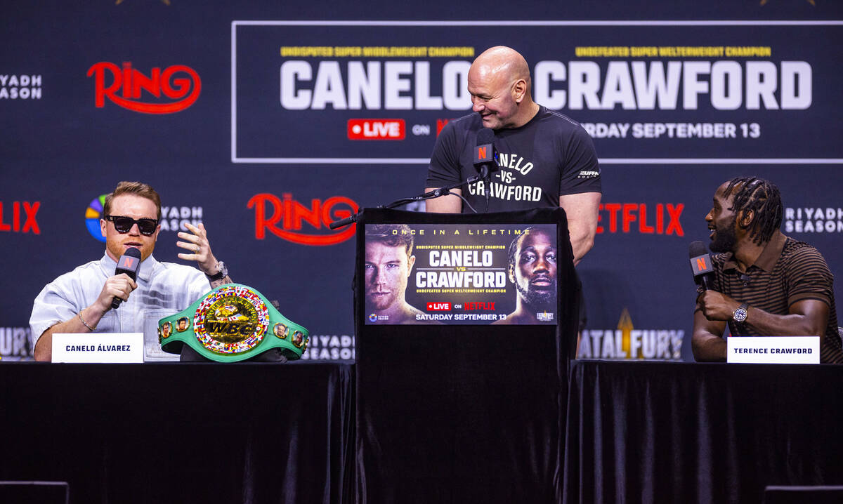 Canelo Alvarez and Terence Crawford exchange words as Dana White looks on during a press confe ...