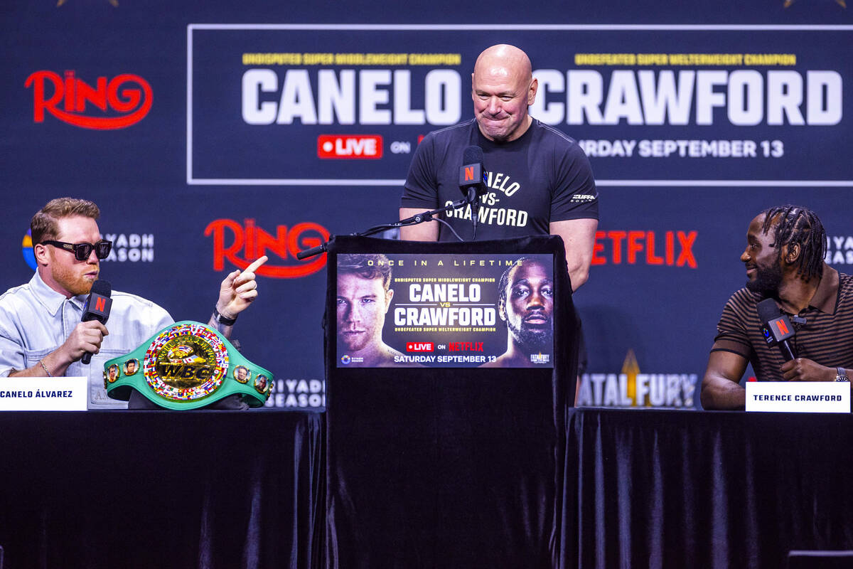 Canelo Alvarez and Terence Crawford exchange words as Dana White looks on during a press confe ...
