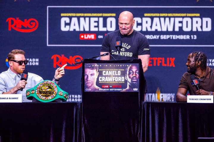 Canelo Alvarez and Terence Crawford exchange words as Dana White looks on during a press confe ...