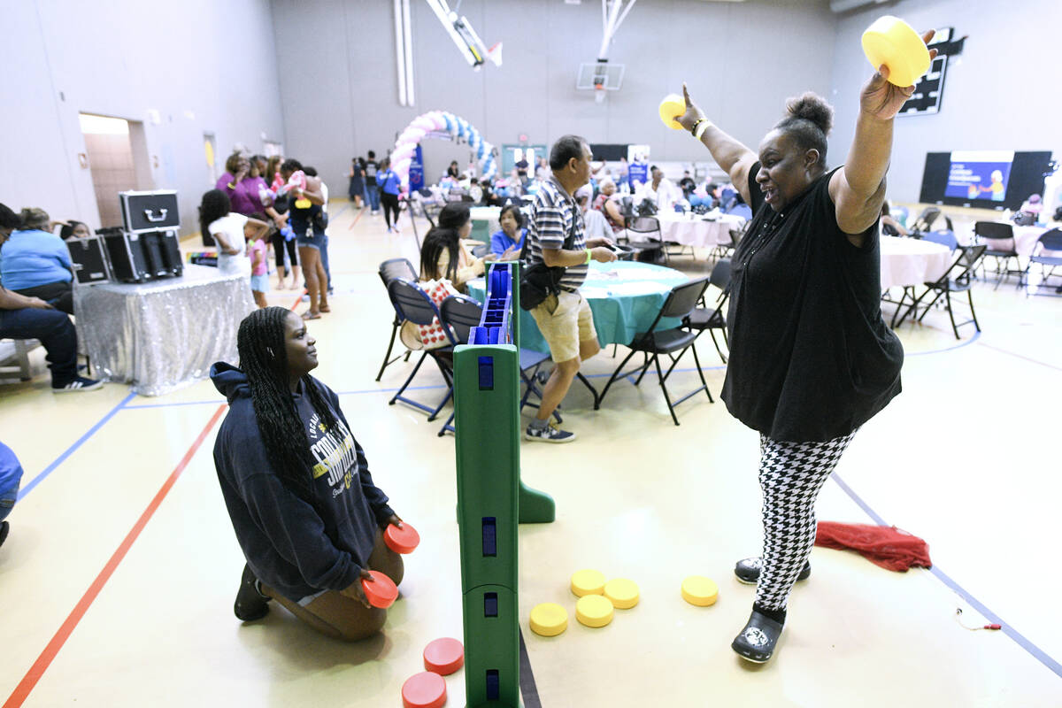 Tina Harper, right, celebrates beating her granddaughter Harmonie Coney in a game of Connect 4 ...