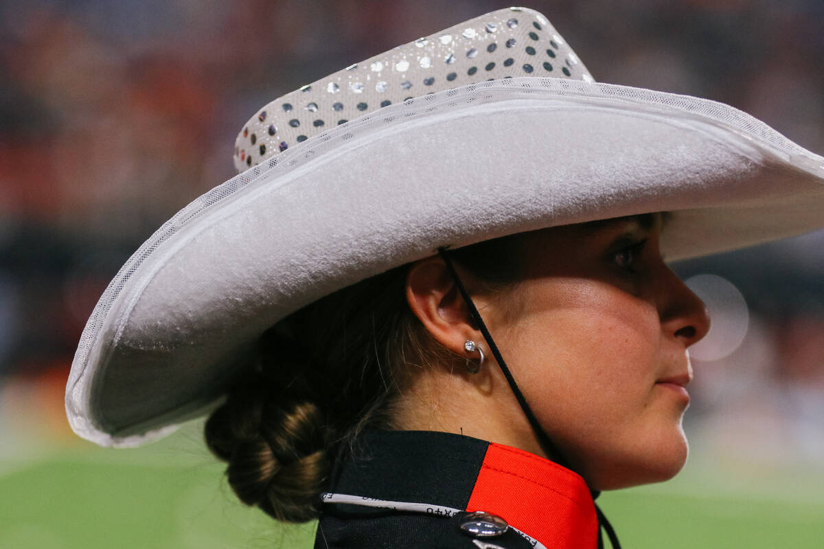 A UNLV marching band member stands on the sidelines during the first half of the football game ...