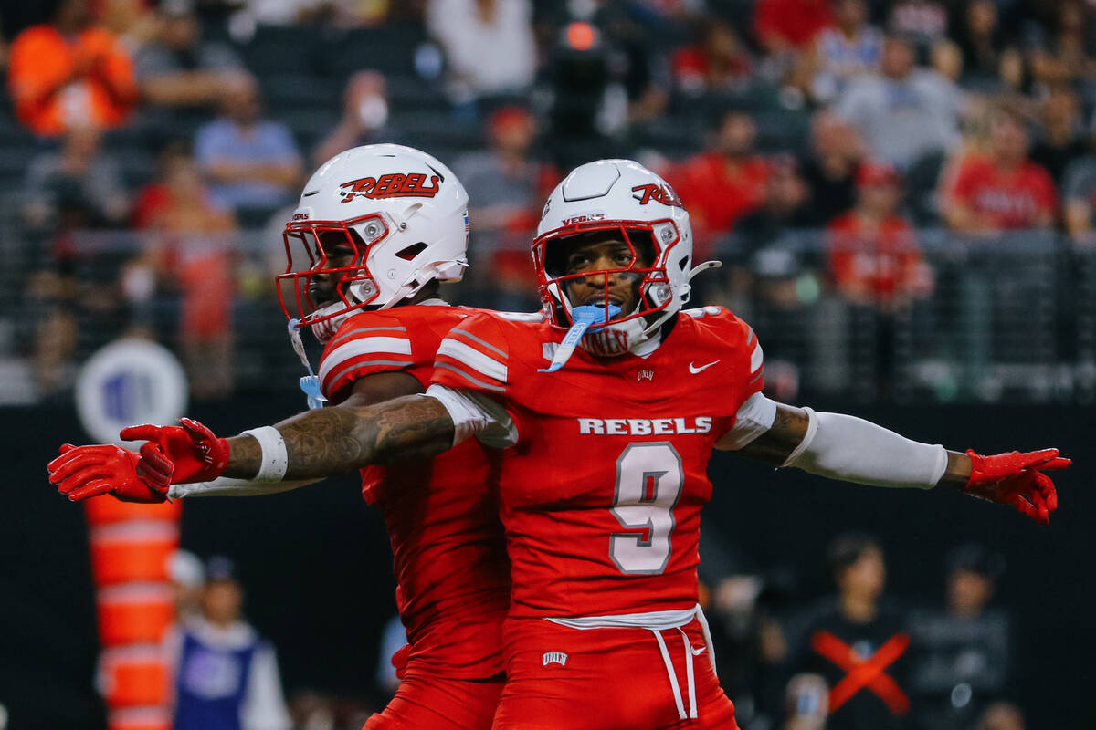 UNLV defensive back Laterrance Welch (0) and UNLV defensive back Aamaris Brown (9) celebrate ma ...