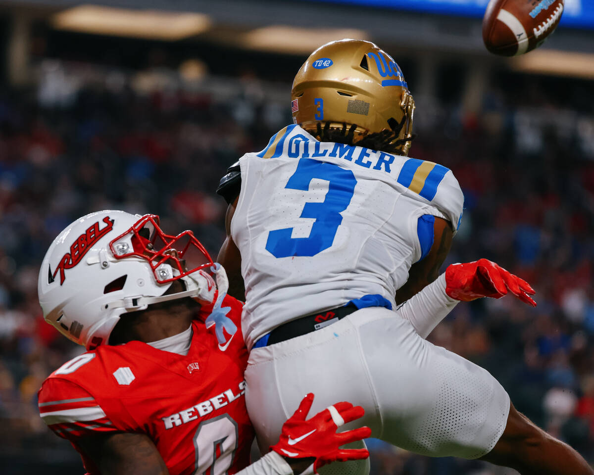 UNLV defensive back Laterrance Welch (0) breaks up a pass intended for UCLA wide receiver Kwazi ...