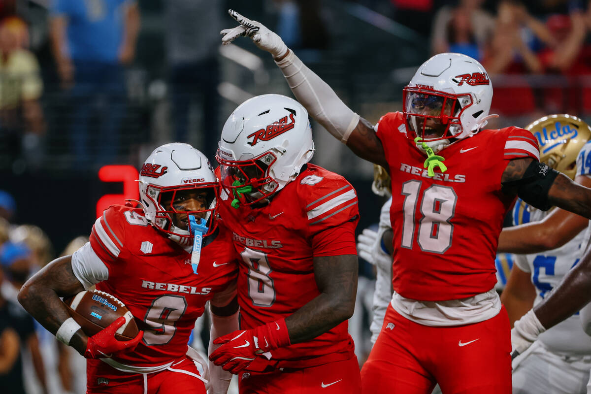 UNLV players celebrate an interception made by UNLV defensive back Aamaris Brown (9) during sec ...
