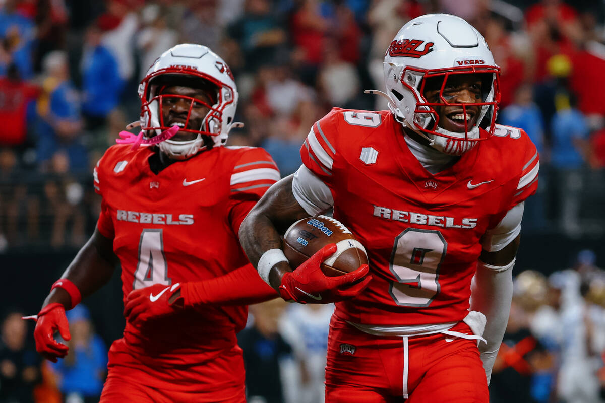UNLV players celebrate an interception made by UNLV defensive back Aamaris Brown (9) during sec ...