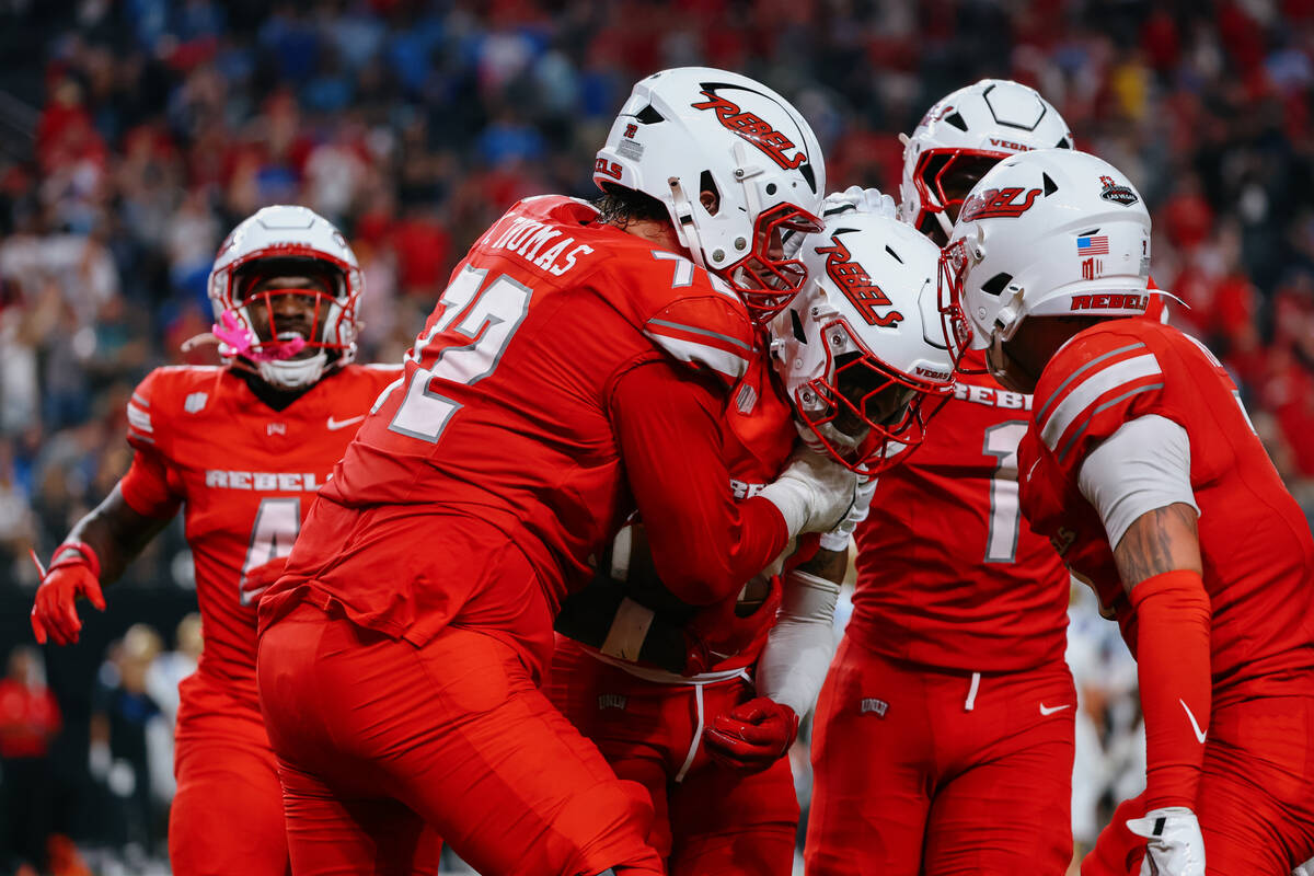 UNLV players celebrate an interception made by UNLV defensive back Aamaris Brown (9) during sec ...