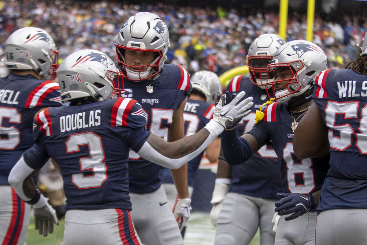 New England Patriots wide receiver DeMario Douglas (3) celebrates his touchdown with wide recei ...