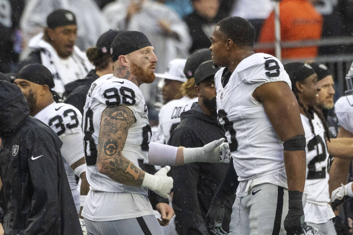 Raiders defensive ends Maxx Crosby (98) and Tyree Wilson (9) celebrate the team’s 20-13 ...