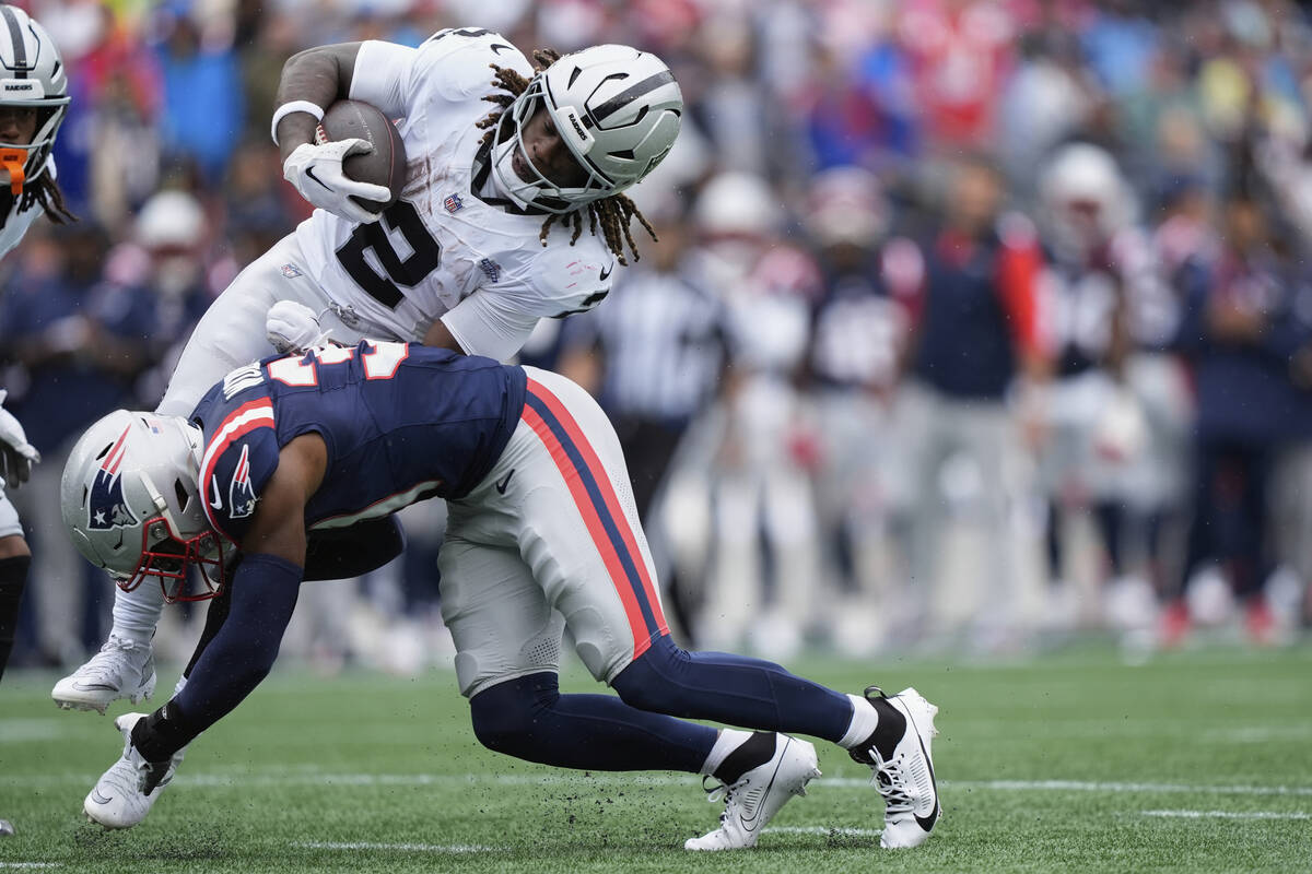 New England Patriots safety Craig Woodson (31) tackles Las Vegas Raiders running back Ashton Je ...