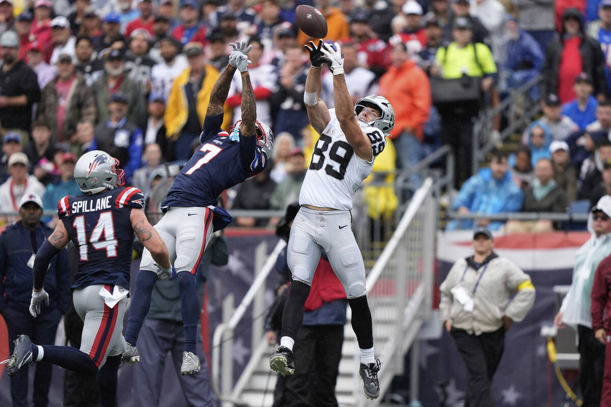 Las Vegas Raiders tight end Brock Bowers (89) misses a catch attempt beside New England Patriot ...