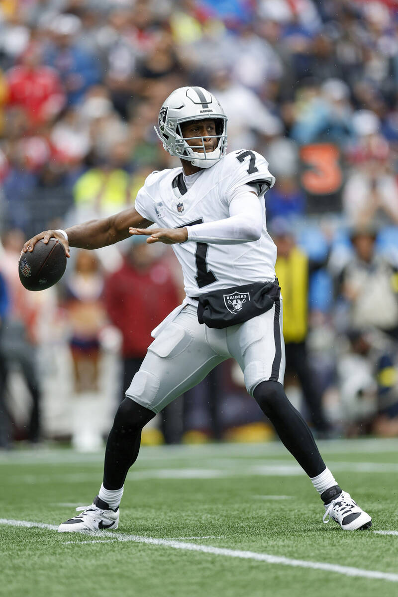 Las Vegas Raiders quarterback Geno Smith (7) drops back to make a pass during the first half of ...