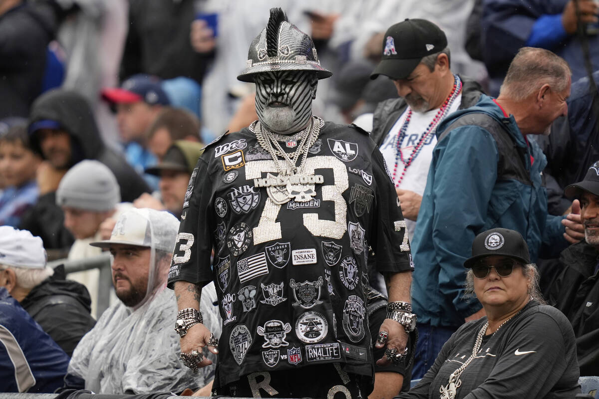 A Las Vegas Raiders fan watches during the first half of an NFL football game between the Las V ...
