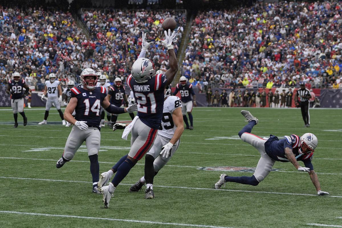 New England Patriots safety Jaylinn Hawkins (21) makes an interception against the Las Vegas Ra ...
