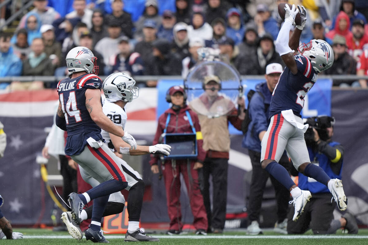 New England Patriots safety Jaylinn Hawkins (21) makes an interception against the Las Vegas Ra ...