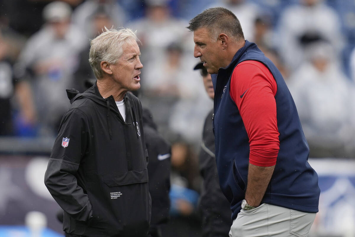 Las Vegas Raiders head coach Pete Carroll, left, and New England Patriots head coach Mike Vrabe ...