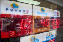 An electronic sign reads $1.8 billion as crowds wait in line to buy lottery tickets at the Blue ...