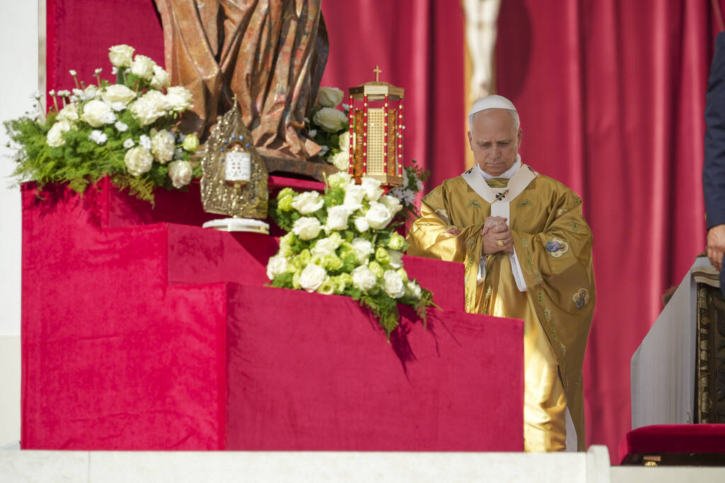 Relics of Carlo Acutis and Pier Giorgio Frassati, left, are displayed during their canonization ...