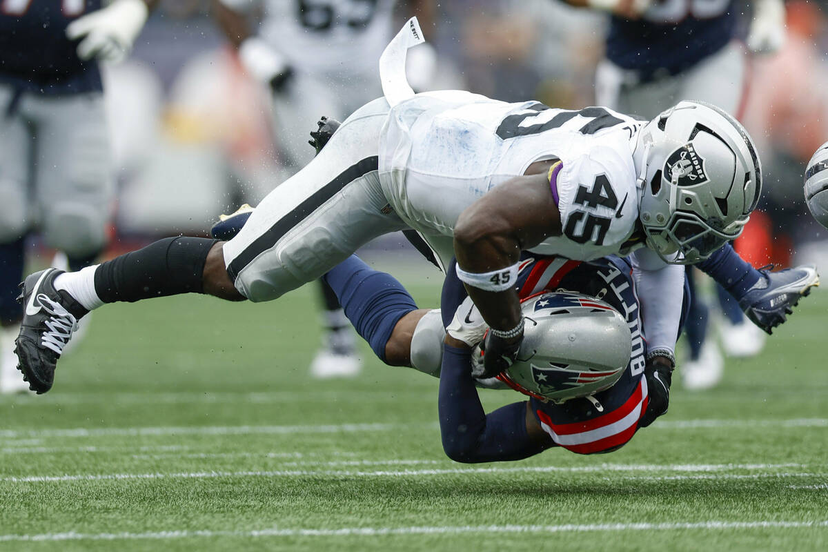 New England Patriots wide receiver Kayshon Boutte (9) is tackled by Las Vegas Raiders linebacke ...