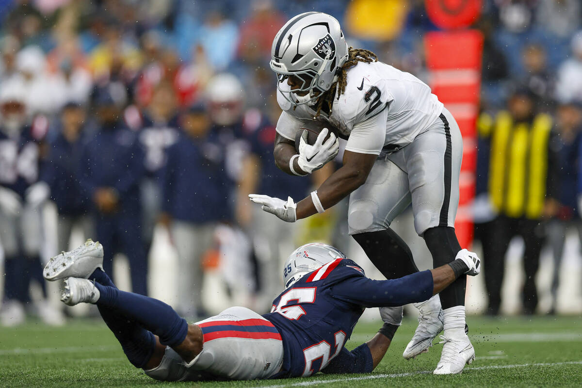 Las Vegas Raiders running back Ashton Jeanty (2) is tackled by New England Patriots cornerback ...