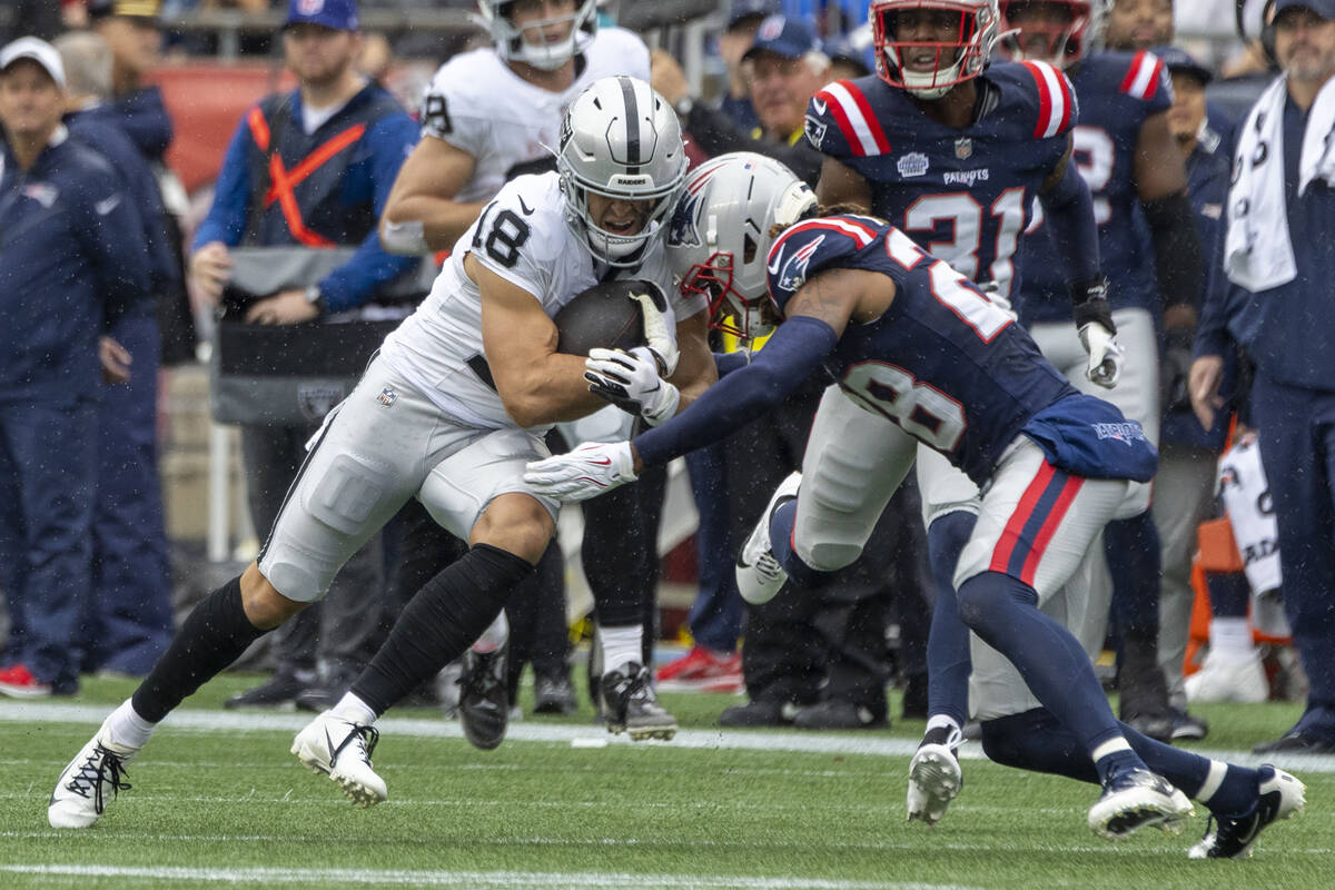 Raiders wide receiver Jack Bech (18) makes a catch with New England Patriots cornerback Alex Au ...