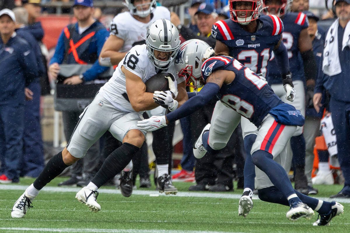 Raiders wide receiver Jack Bech (18) makes a catch with New England Patriots cornerback Alex Au ...