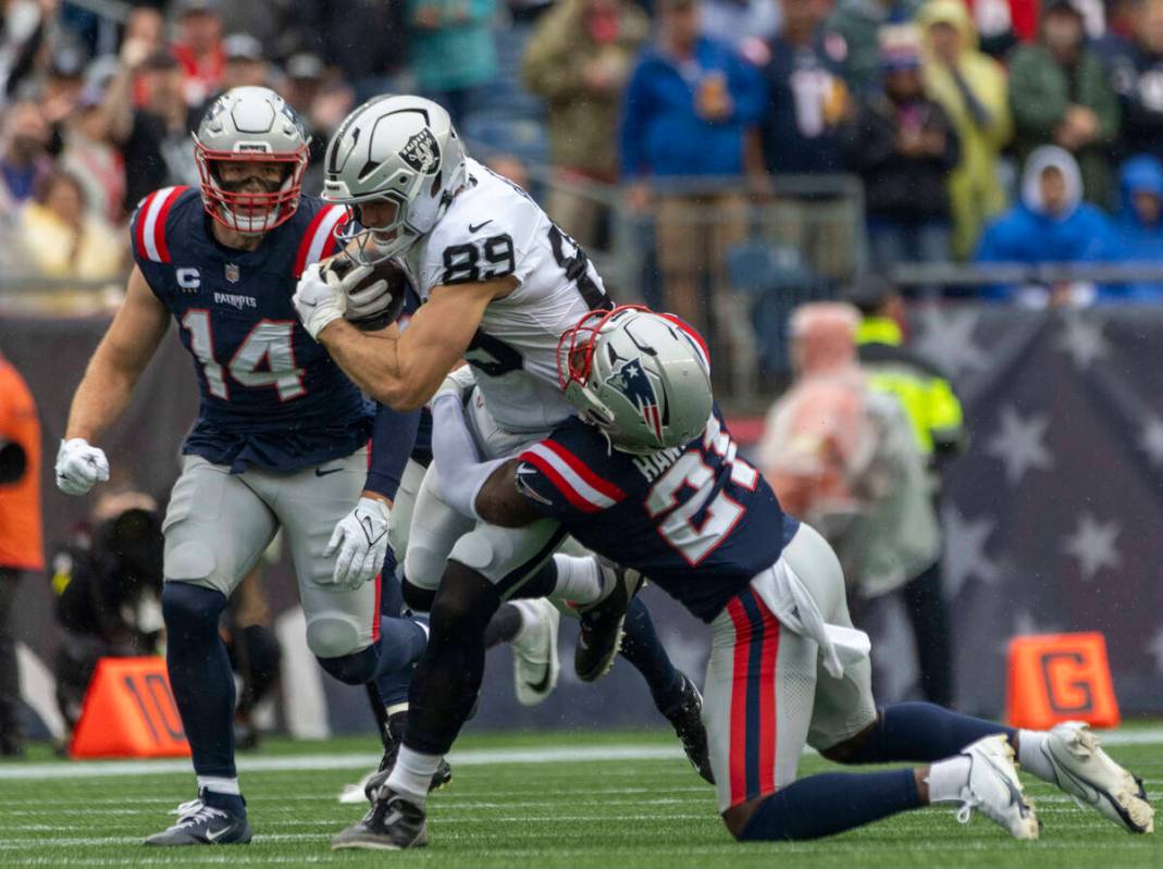 Raiders tight end Brock Bowers (89) is tackled by New England Patriots safety Jaylinn Hawkins ( ...