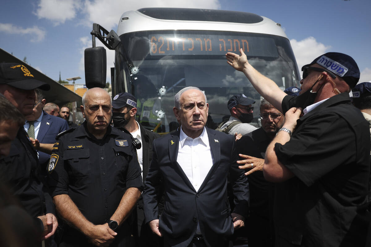 Israel's Prime Minister Benjamin Netanyahu visits the site of a shooting attack at a bus s ...