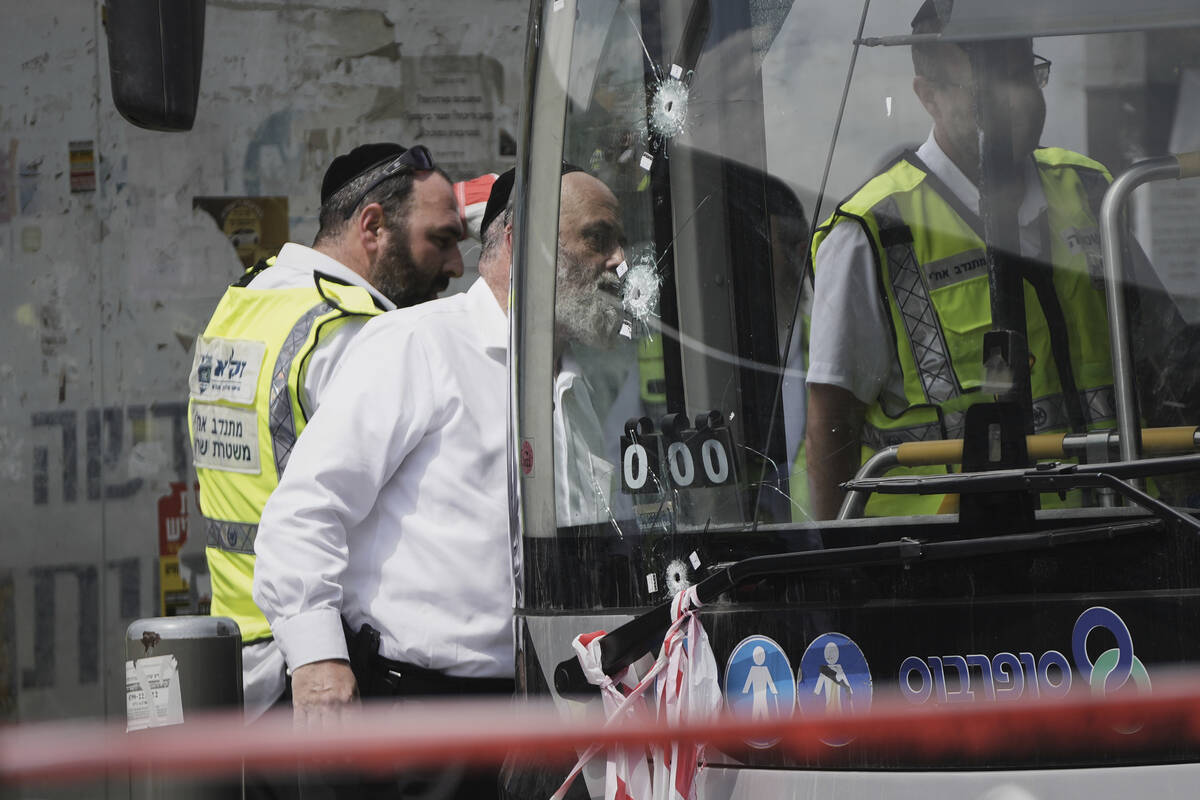Israeli police and rescue teams inspect the scene of a shooting attack carried out by two Pales ...