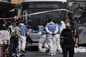 Israeli police and rescue teams inspect the scene of a shooting attack carried out by two Pales ...