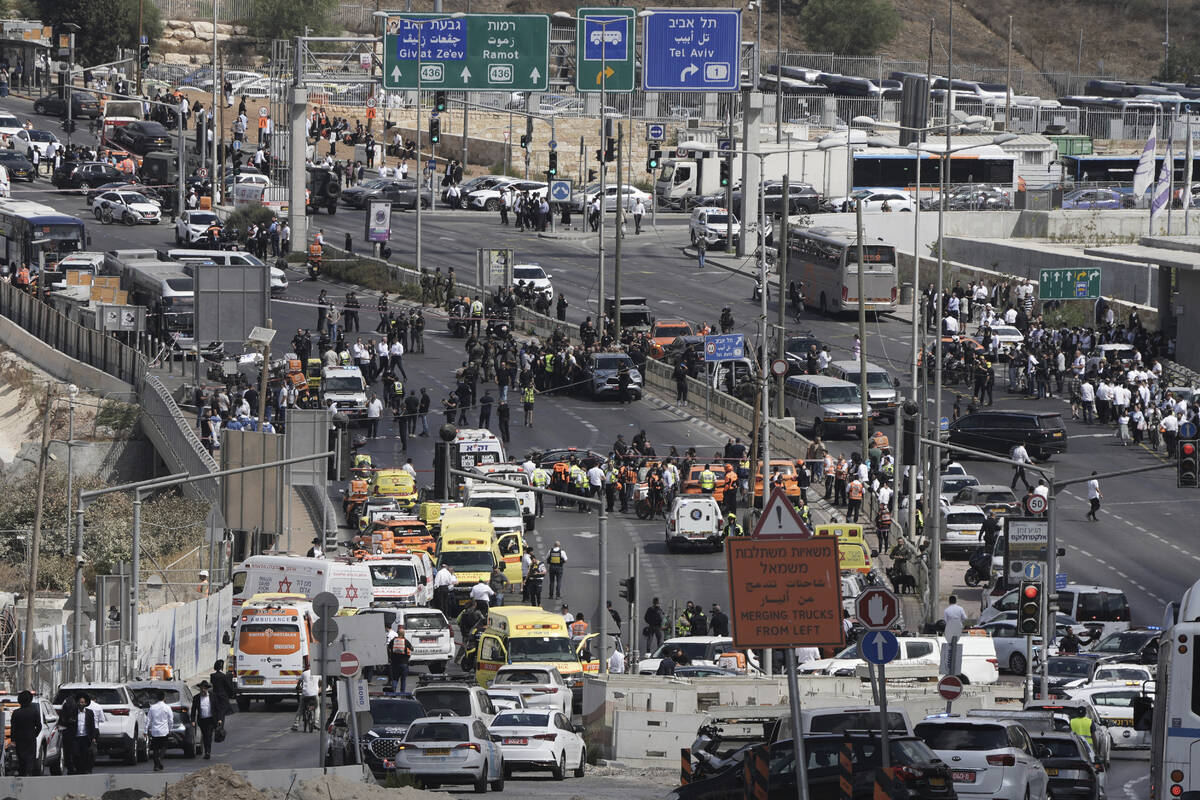 Israeli police and rescue teams respond at the scene of a shooting attack where several people ...