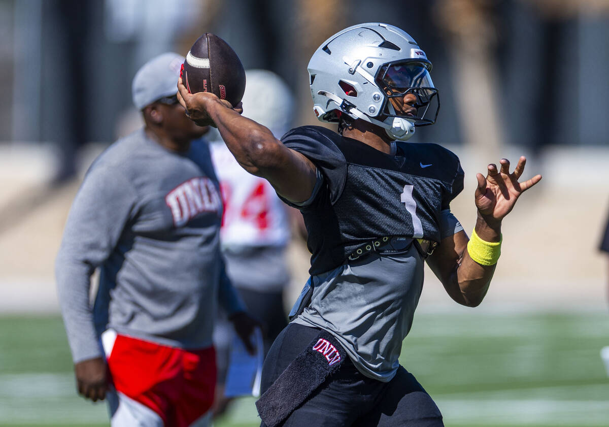 UNLV quarterback Alex Orji (1) sets up a pass during football practice at the Fertitta Football ...