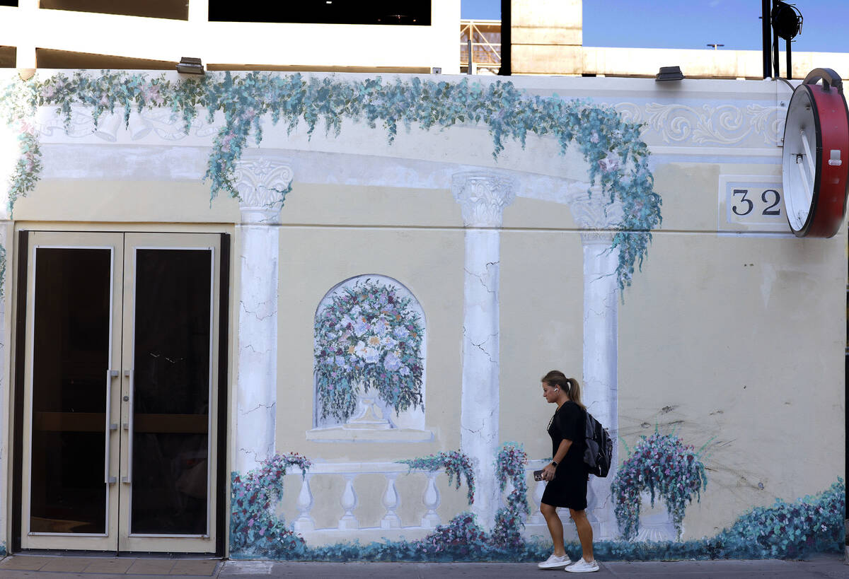 A pedestrian walks past a closed wedding chapel that sold this year at 320 S 3rd St., on Friday ...