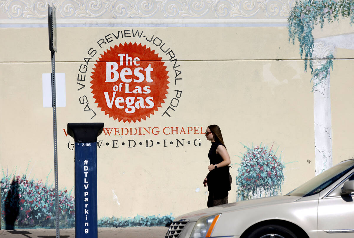 A pedestrian walks past a closed wedding chapel that sold this year at 320 S 3rd St., on Friday ...