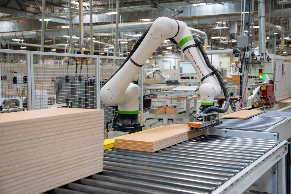 Cooperative robots are used on the factory floor of the Foliot Furniture manufacturing plant in ...