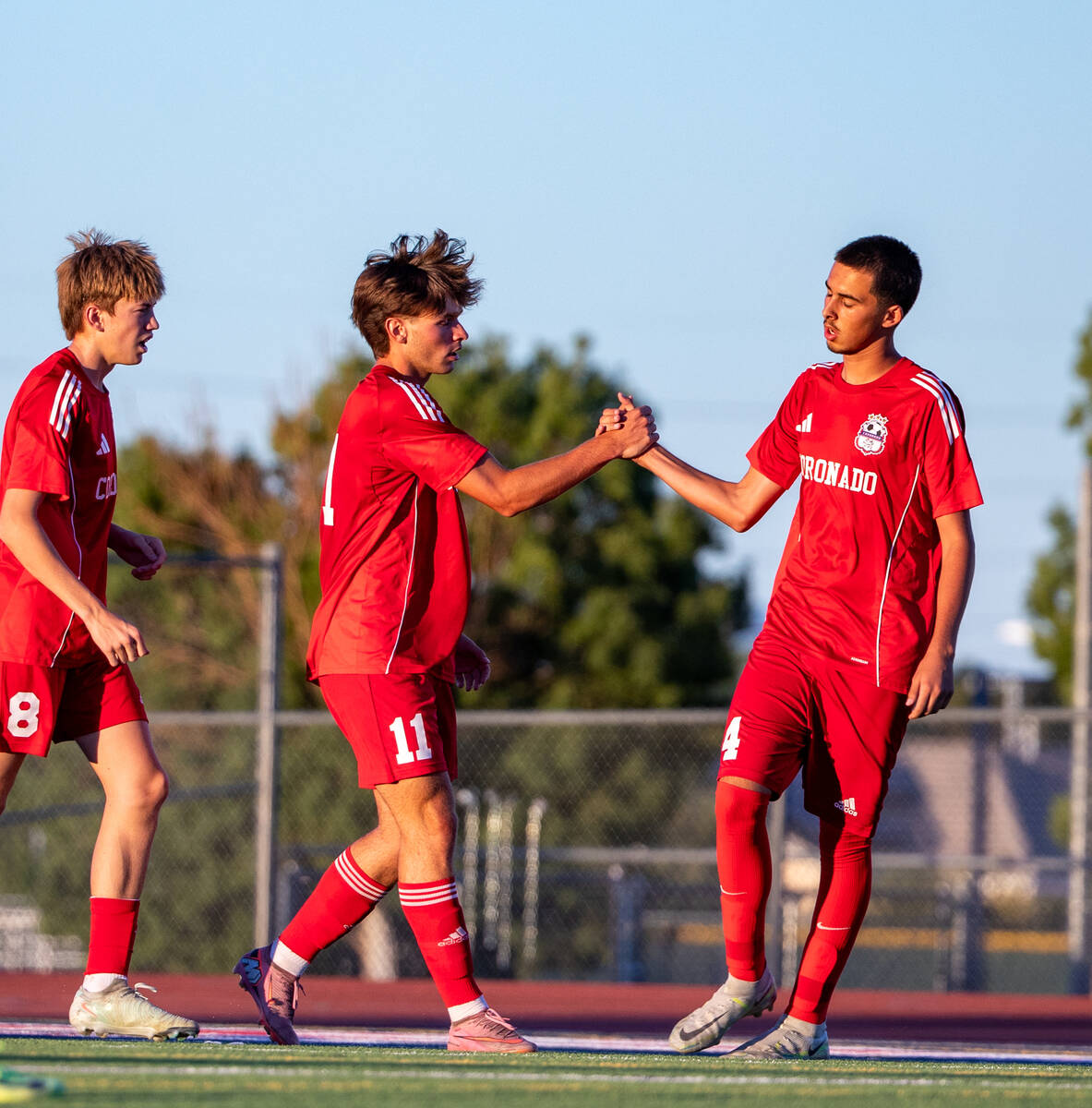 Coronado striker Gavin Flickinger (11) and midfielder Gavin Biddinger (14) celebrate after a go ...