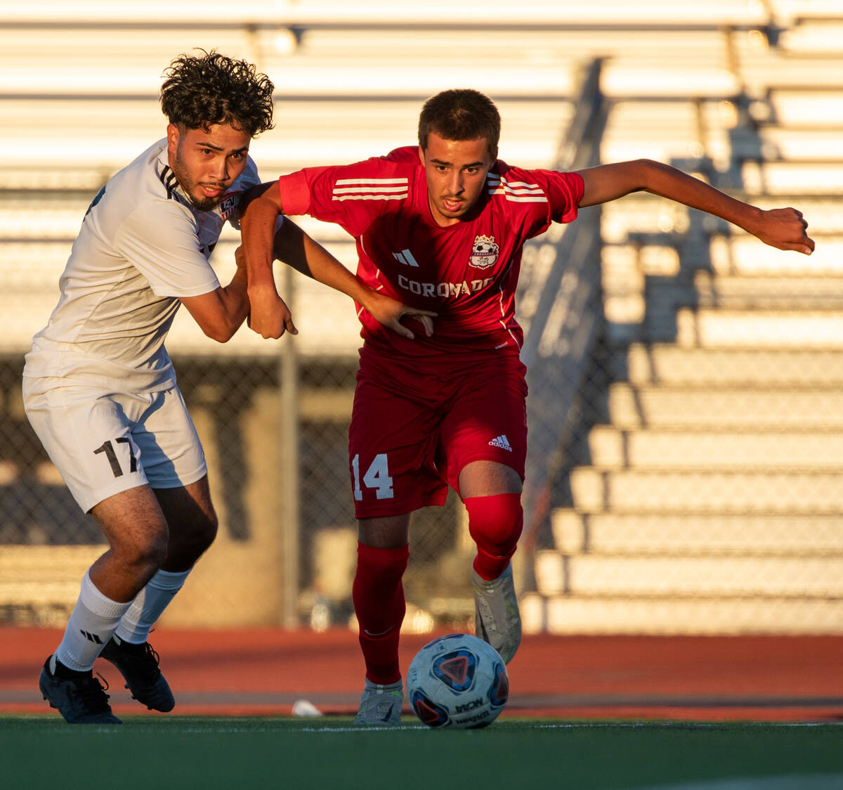 Coronado midfielder Gavin Biddinger (14) attempts to get past Xavier Venavides Monroy (17) duri ...