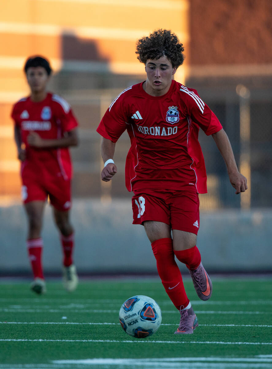 Coronado midfielder Josh Pineda (18) takes the ball upfield during a soccer match at Coronado H ...