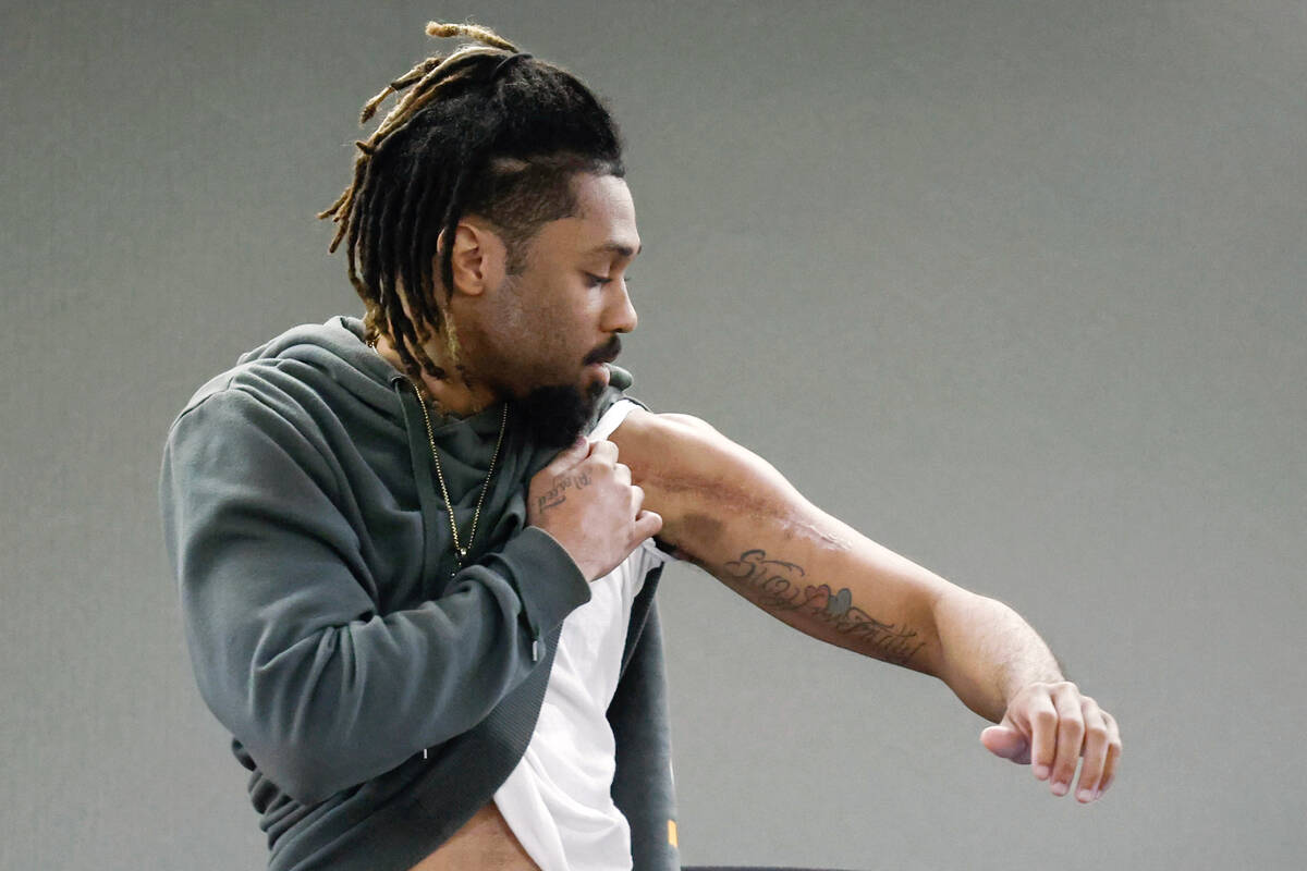 Isaiah Armstrong shows the jury some of the injuries he sustained on the first day of Christoph ...