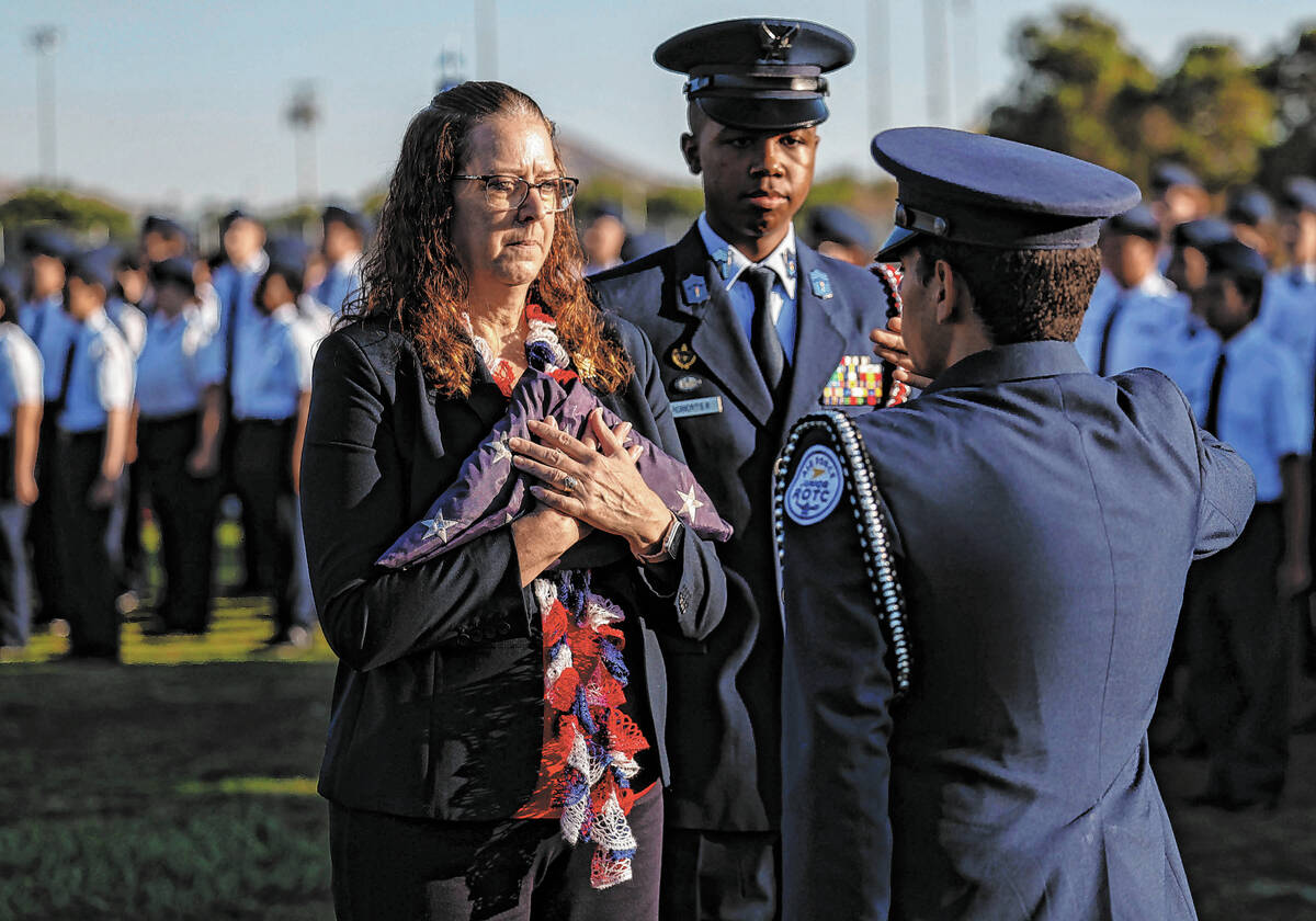 Palo Verde teacher Carol Campbell, left, accepts an American flag from members of the school’ ...