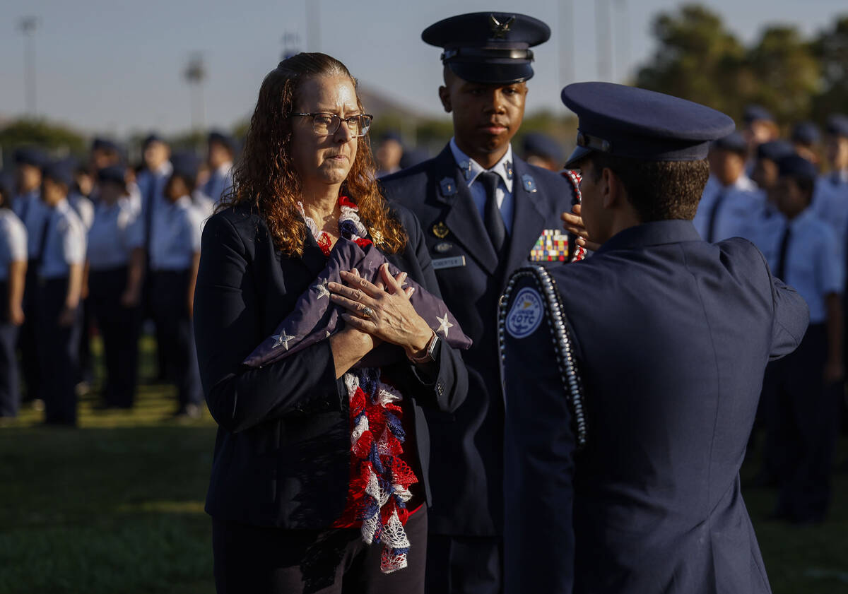 Palo Verde teacher Carol Campbell, left, accepts an American flag from members of the school&#x ...